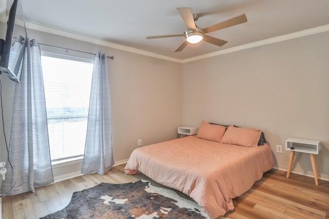 bedroom with ornamental molding, light wood-type flooring, multiple windows, and ceiling fan