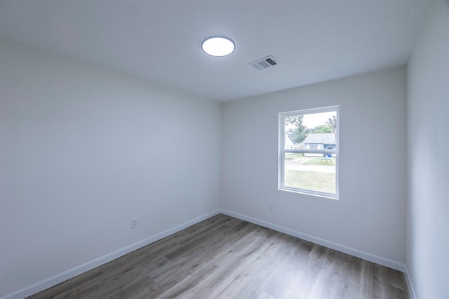 empty room with hardwood / wood-style flooring