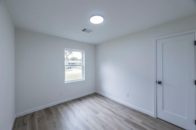 spare room with light hardwood / wood-style floors