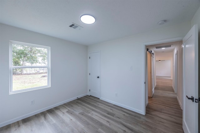 unfurnished bedroom featuring a closet and light hardwood / wood-style flooring