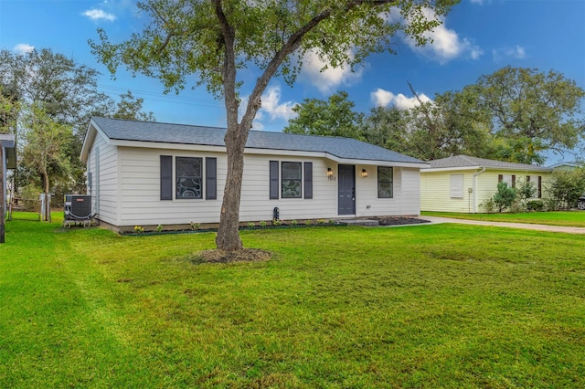 single story home featuring central air condition unit and a front lawn