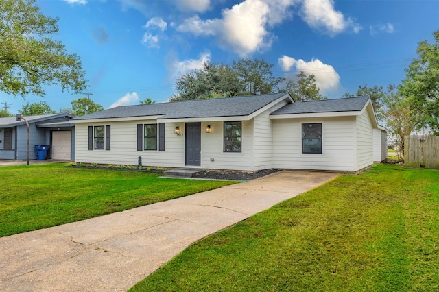 ranch-style house featuring a garage and a front yard