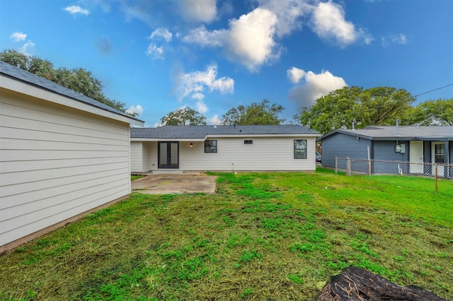 rear view of property featuring a yard and a patio