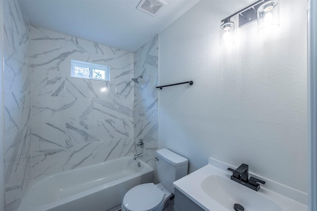 full bathroom featuring tiled shower / bath combo, toilet, and vanity