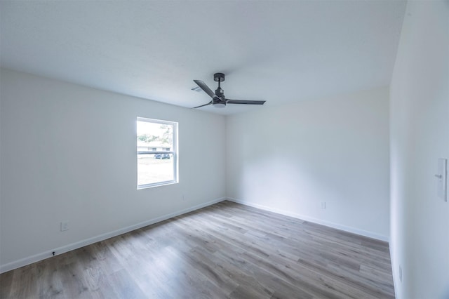 spare room featuring light hardwood / wood-style floors and ceiling fan