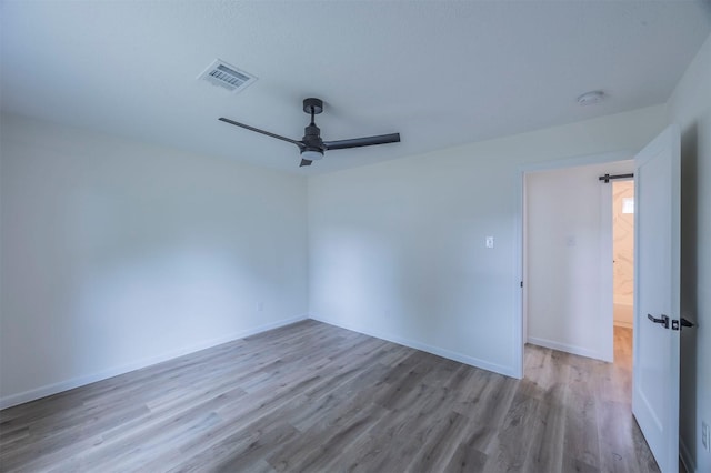 empty room with light wood-type flooring and ceiling fan