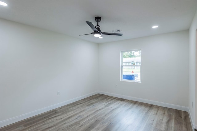 spare room with ceiling fan and light wood-type flooring