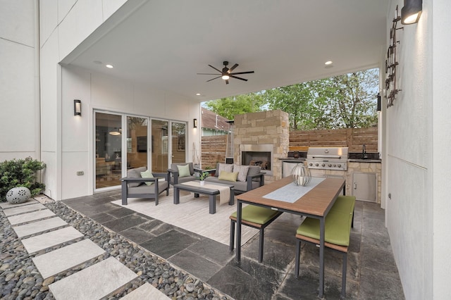 view of patio / terrace with an outdoor kitchen, a grill, sink, an outdoor stone fireplace, and ceiling fan