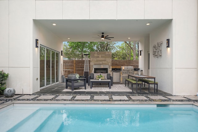 view of pool featuring area for grilling, ceiling fan, a patio area, and an outdoor stone fireplace