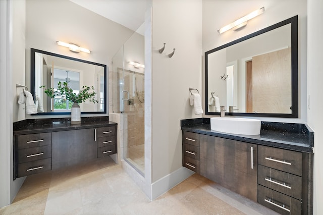 bathroom with tiled shower and vanity