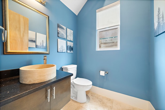 bathroom with tile patterned flooring, vanity, and toilet