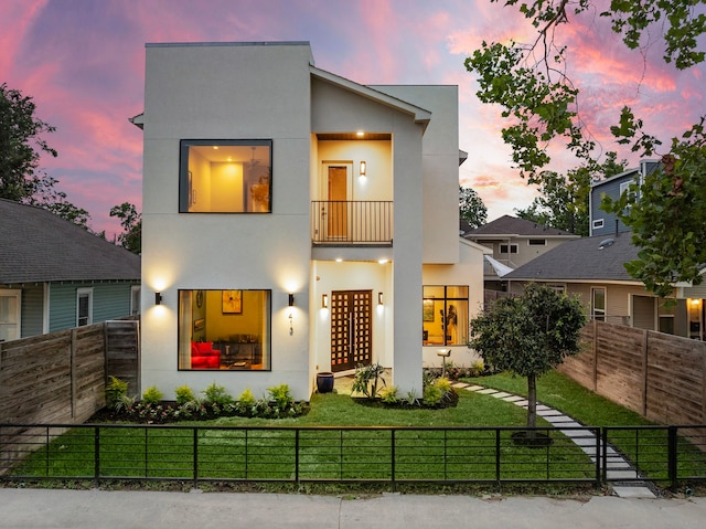 modern home with a yard and a balcony