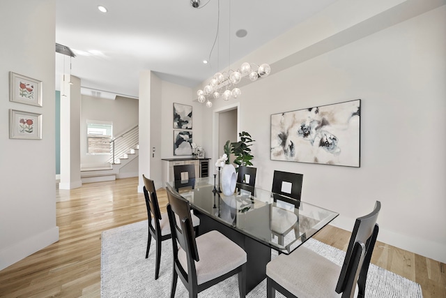 dining space with wine cooler and light wood-type flooring