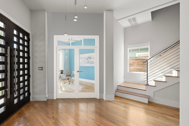 interior space with french doors, lofted ceiling, and hardwood / wood-style floors