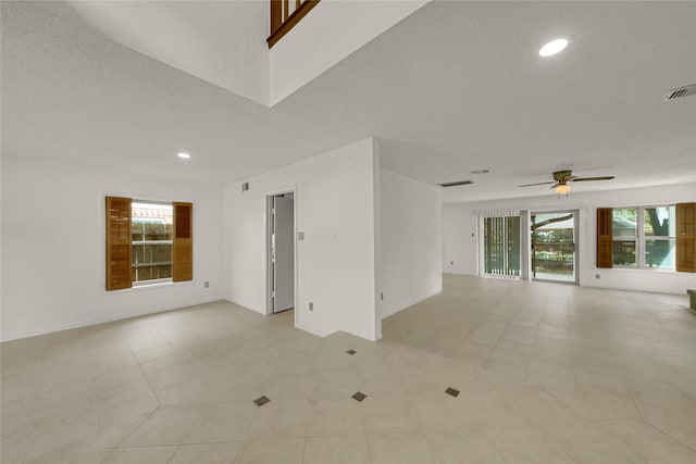 3327 Larkwood Ln, Sugar Land, TX 77479 - empty room featuring a ceiling fan, recessed lighting, light tile patterned flooring, baseboards, and a textured ceiling