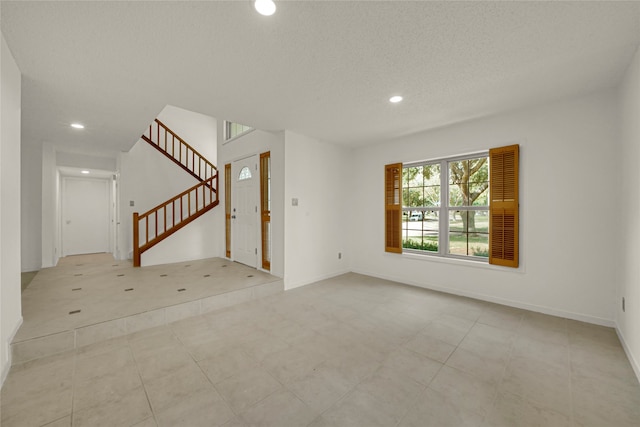 empty room featuring a textured ceiling