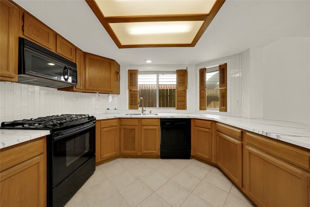 kitchen with black appliances, backsplash, sink, and light tile patterned floors