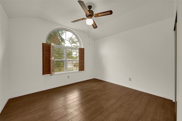 unfurnished room with a textured ceiling, dark hardwood / wood-style floors, ceiling fan, and vaulted ceiling