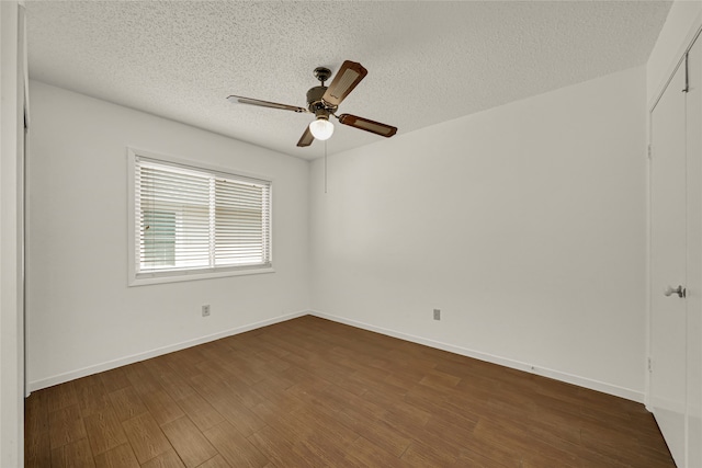 unfurnished room with dark wood-type flooring, ceiling fan, and a textured ceiling