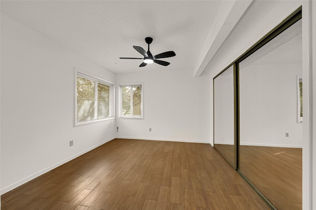 3327 Larkwood Ln, Sugar Land, TX 77479 - unfurnished bedroom featuring wood finished floors, baseboards, ceiling fan, and a closet