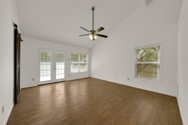 3327 Larkwood Ln, Sugar Land, TX 77479 - empty room with plenty of natural light, a ceiling fan, high vaulted ceiling, and dark wood-type flooring