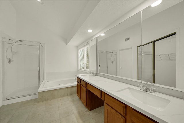 bathroom featuring tile patterned flooring, vanity, vaulted ceiling, and independent shower and bath