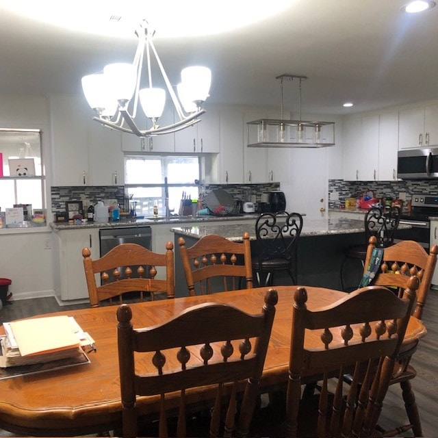 dining space featuring a chandelier and hardwood / wood-style floors