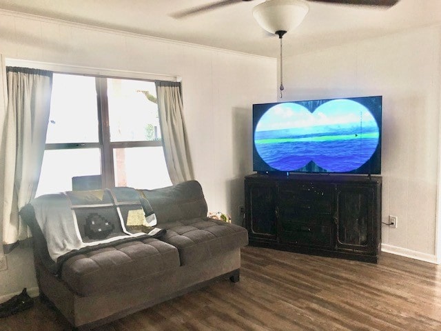 living room featuring ceiling fan, wood-type flooring, and crown molding