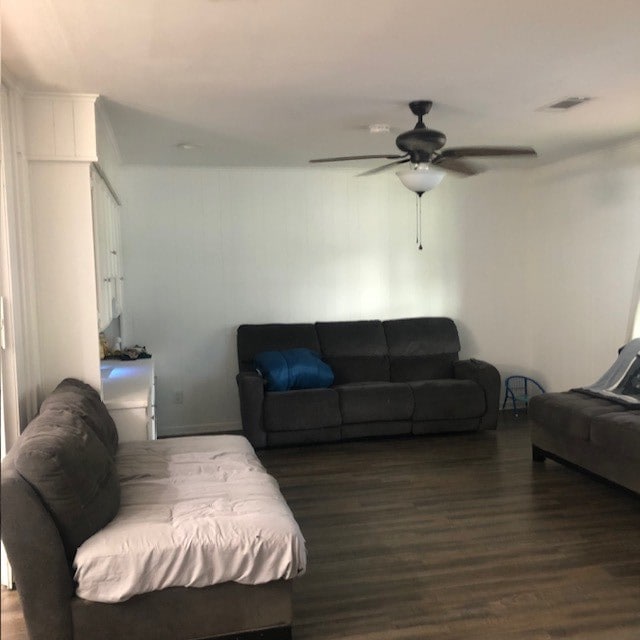 living room featuring dark hardwood / wood-style floors and ceiling fan