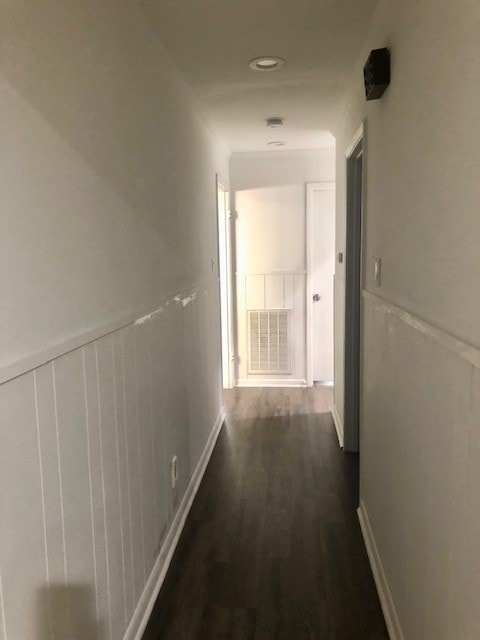 hallway featuring dark hardwood / wood-style flooring