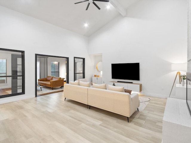 living room with high vaulted ceiling, light hardwood / wood-style flooring, beamed ceiling, and ceiling fan