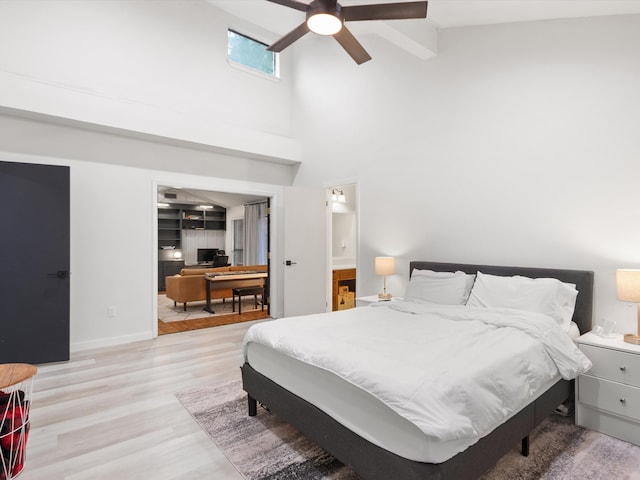 bedroom featuring high vaulted ceiling, light hardwood / wood-style floors, and ceiling fan