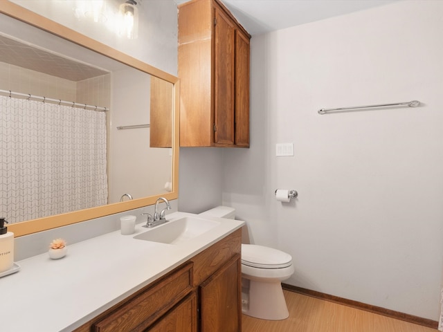 bathroom featuring hardwood / wood-style floors, curtained shower, vanity, and toilet