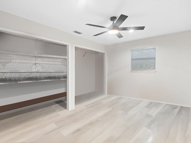 unfurnished bedroom with ceiling fan and light hardwood / wood-style flooring