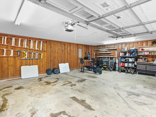 garage featuring wood walls and a garage door opener