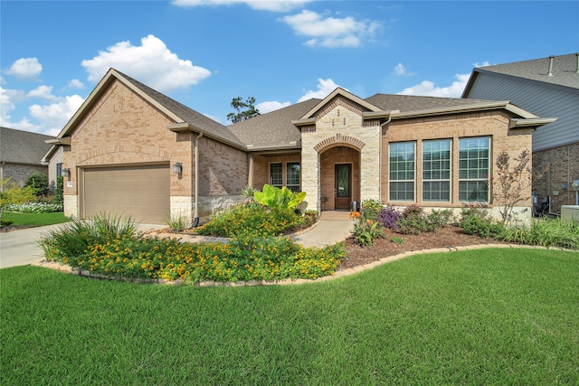 view of front of house with a garage and a front yard