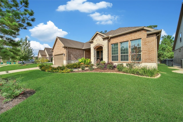 view of front of property with a garage and a front yard