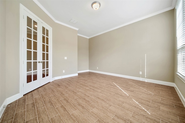 empty room with french doors, hardwood / wood-style flooring, and crown molding