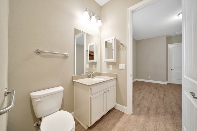 bathroom featuring vanity, hardwood / wood-style flooring, and toilet