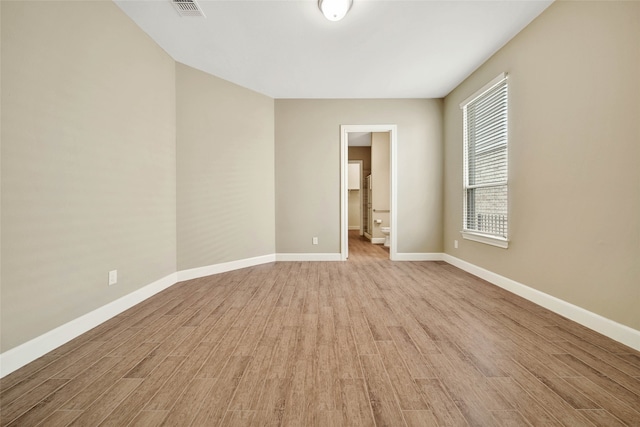 unfurnished room with light wood-type flooring