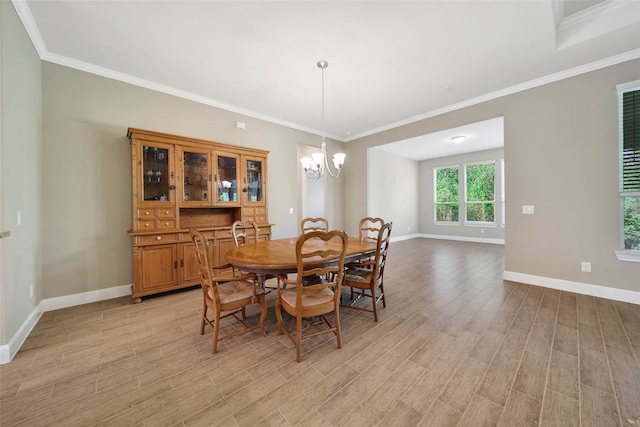 dining room with light wood-type flooring, a chandelier, and crown molding