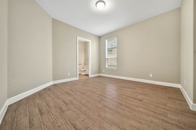 unfurnished room with light wood-type flooring