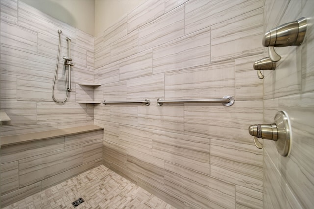 bathroom with a tile shower