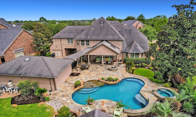 view of swimming pool with a patio area and an in ground hot tub