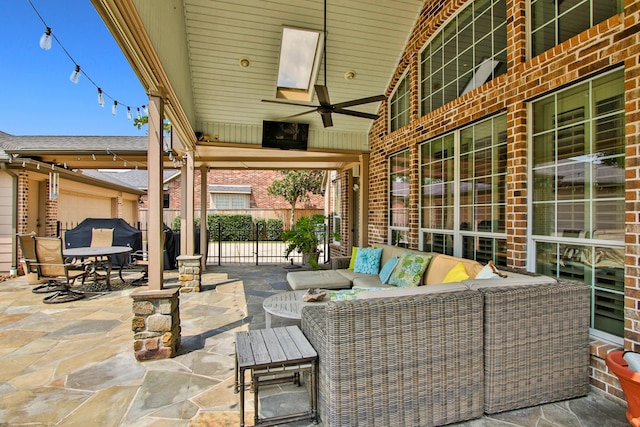 view of patio with ceiling fan and an outdoor living space