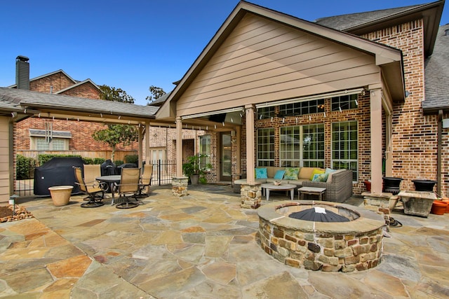 view of patio / terrace with an outdoor living space with a fire pit