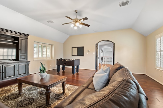 living room with dark hardwood / wood-style flooring, a wealth of natural light, vaulted ceiling, and ceiling fan