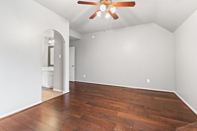 spare room featuring wood-type flooring, vaulted ceiling, and ceiling fan