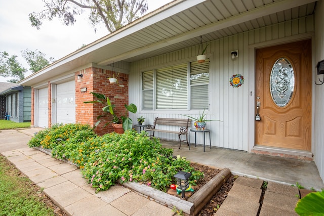 property entrance featuring a garage and covered porch