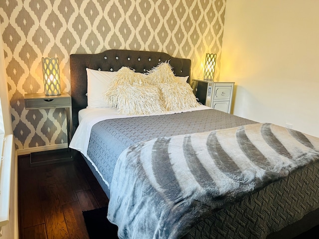 2817 Houston Ave, Houston, TX 77009 - bedroom with wallpapered walls, wood-type flooring, and baseboards